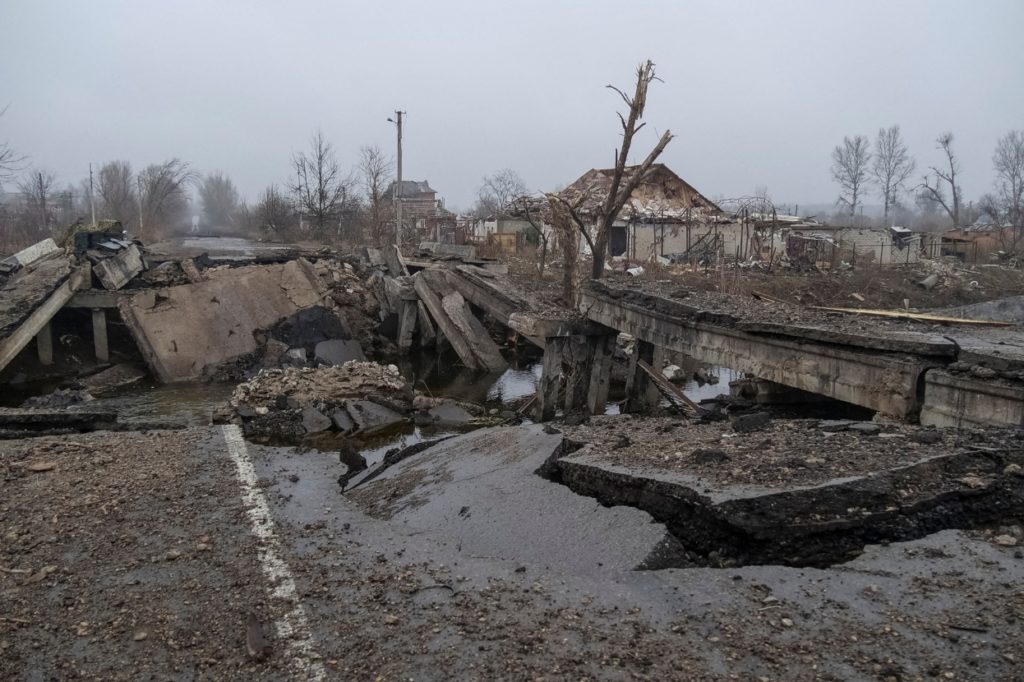 Autonomous drones for defence logistics: Damaged bridge and buildings in conflict-affected area.