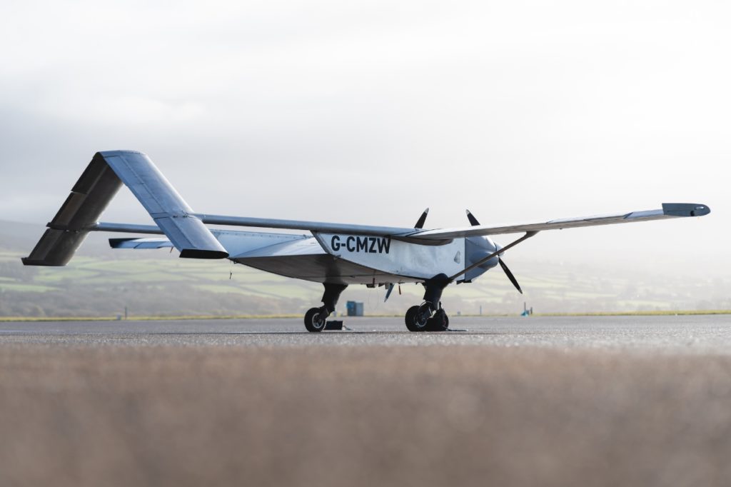 Autopilot: Fixed-wing cargo drone positioned on runway ready for take-off.