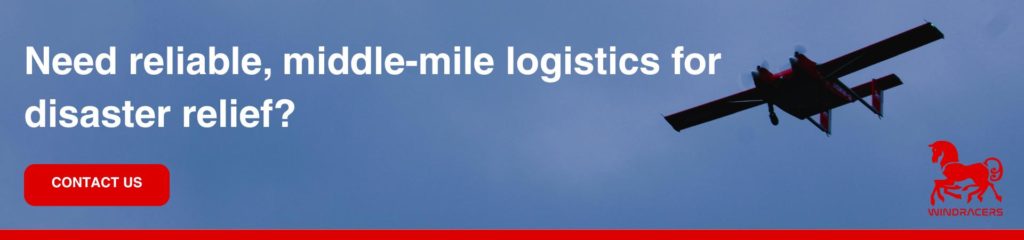 Need reliable middle-mile logistics for disaster relief A banner showing a Windracers uncrewed aircraft in flight against a grey-blue sky, overlaid with the text "Need reliable, middle-mile logistics for disaster relief?" alongside a red "Contact Us" button and the Windracers logo.